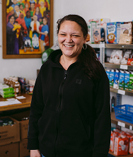 A woman standing in front of a stocked pantry