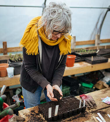 A woman planting seeds