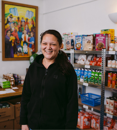 A woman standing in front of a shelf full of food