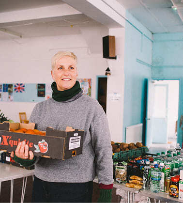A woman holding a donated box of food