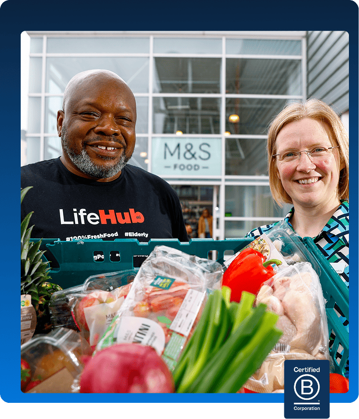 A man from a charity collecting a food donation from an M&S employee